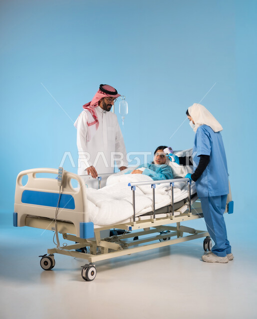 The feeling of a person suffering from fatigue and the importance of taking care of him, caring for and taking care of children, a side portrait of a Saudi Arabian Gulf nurse wearing a work uniform, checking the patient’s temperature using a digital device, following precautionary measures against the Corona virus, a blue background