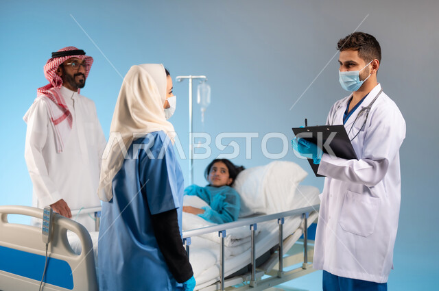 تدوين وتسجيل معلومات المريضة, اتباع اجراءات الوقاية من فايروس كورونا, بورتريه من الجانب لممرضة عربية خليجية سعودية ترتدي يونيفورم العمل والكمامة تقوم بإعطاء المعلومات للطبيب, مفهوم الاهتمام بالصحة, العمل في القطاع الطبي السعودي, خلفية زرقاء