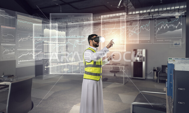 العمل بالقطاع الهندسي عبر تقنية الواقع الافتراضي، التفاعل مع الهندسة الافتراضية، مهندس عربي خليجي سعودي يرتدي سترة العمل ونظارة الفي آر يتفاعل مع مجسم لمخطط بناء هولوجرامي، رؤية مستقبلية سعودية 2030، نمو المجال الهندسي التكنولوجي