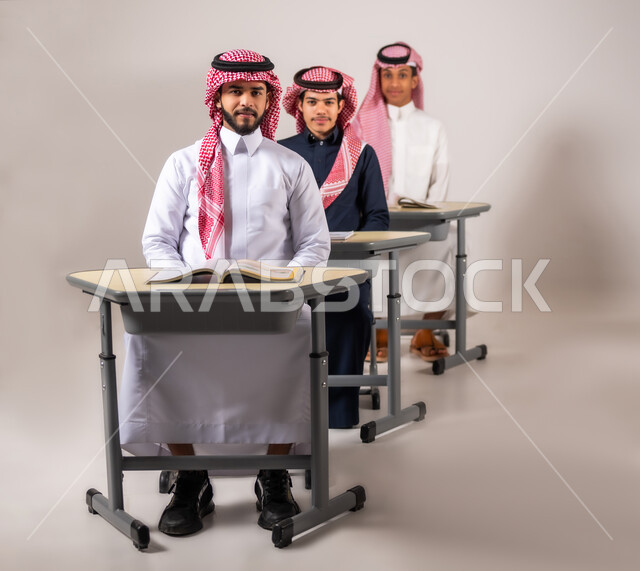 Achievement and success in the educational stages, a group of Saudi students looking at the camera with gestures of happiness and pleasure at success, goals of education, end-of-semester exam, gray background