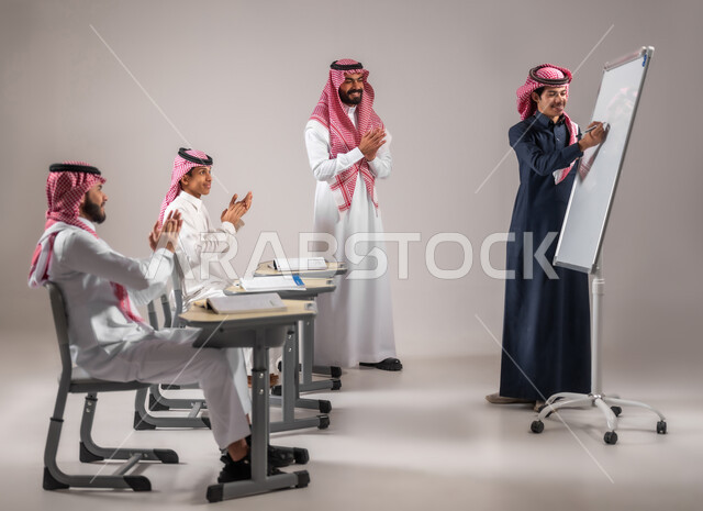 Education according to the prescribed curriculum, active participation in the class, gestures of encouragement and applause inside the classroom, a portrait of a Saudi Gulf Arab student wearing the traditional dress explaining and answering the teacher’s question in front of the students, using the white school board, gray background.