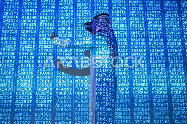 Programming codes and algorithms, the concept of cybersecurity, a Saudi Gulf Arab man wearing a traditional thobe and shemagh, wearing VR glasses, pointing with his index finger at the codes, a 3D hologram background