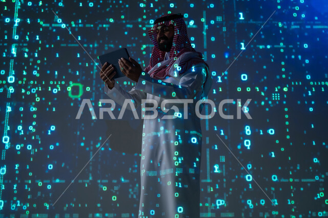 Working on modern electronic devices, using programming languages, a Saudi Gulf Arab man wearing a traditional thobe and shemagh holding a tablet in his hands, technical and digital development, a 3D hologram background