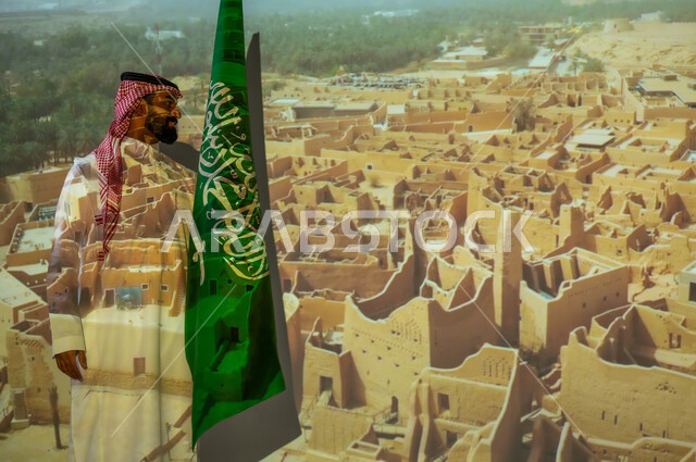 National holidays and events, celebration of the Saudi Flag Day on March 11, commemoration of the Independence Day of Saudi Arabia on September 23, a smiling Saudi Gulf Arab young man wearing traditional clothing and standing next to the flag of the Kingdom of Saudi Arabia, background, Salwa Palace, Diriyah Al-Bujairi in Riyadh, gestures of joy and pleasure