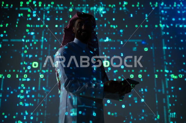 Integrating science with technology and technology, digital and technological progress, a Saudi Gulf Arab man wearing a traditional thobe and shemagh looking at the camera with self-confidence gestures holding a portable tablet in his hand, a 3D hologram background for software algorithms