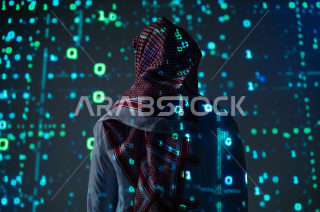 The use of programming languages, digital, technical and technological development, a picture from the back of a Saudi Gulf Arab man wearing the traditional dress and shemagh standing in front of programming codes and algorithms, a three-dimensional holographic background
