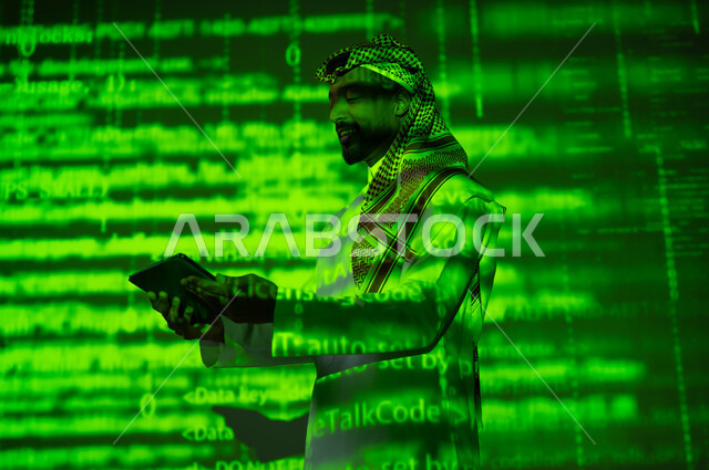 رموز واحرف وارقام، استخدام التقنيات الحديثة, دمج العلم بالتكنولوجيا، أرقام وحسابات في مادة الرياضيات، رجل عربي خليجي سعودي يرتدي الثوب التقليدي والشماغ يحمل بيده جهاز التابلت اللوحي, التطور العلمي و التقني في المملكة, خلفية خضراء للقوانين والمعادلات
