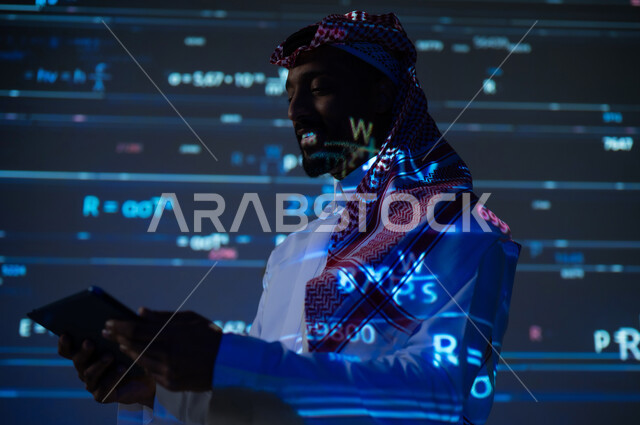 Using modern technologies, integrating science with technology, numbers and calculations in mathematics, a Saudi Gulf Arab man wearing a traditional thobe and shemagh holding a tablet in his hand, scientific and technical development in the Kingdom of Saudi Arabia, a blue background for laws and equations