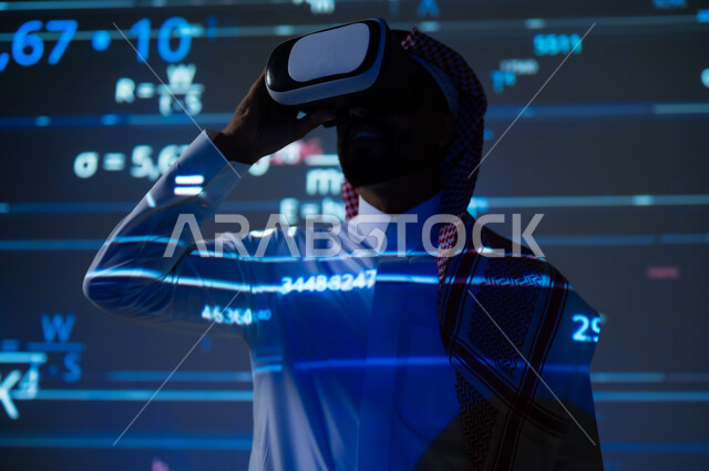 محاكاة الواقع الافتراضي، رؤية مستقبلية 2030 ، التطور العلمي والتقني في المملكة، شاب عربي خليجي سعودي يرتدي الثوب التقليدي والشماغ ينظر من خلال نظارات الفي ار، حسابات و أرقام في المواد العلمية، القوانين والمعادلات الرياضية