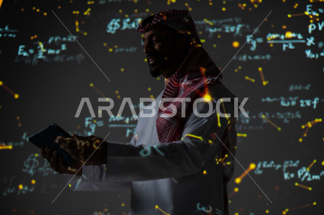 Using modern technologies, integrating science with technology, numbers and calculations in mathematics, a Saudi Gulf Arab man wearing a traditional thobe and shemagh holding a tablet in his hand, scientific and technical development in the Kingdom of Saudi Arabia, a black background for colorful mathematical laws and equations
