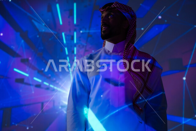 Interest in the electronic sector in the Kingdom of Saudi Arabia, promoting the concept of technological progress and development in Saudi society, modern and advanced technologies, a Saudi Gulf Arab young man wearing a traditional dress looking at the camera with happy gestures, a future vision 2030, blue neon lighting background