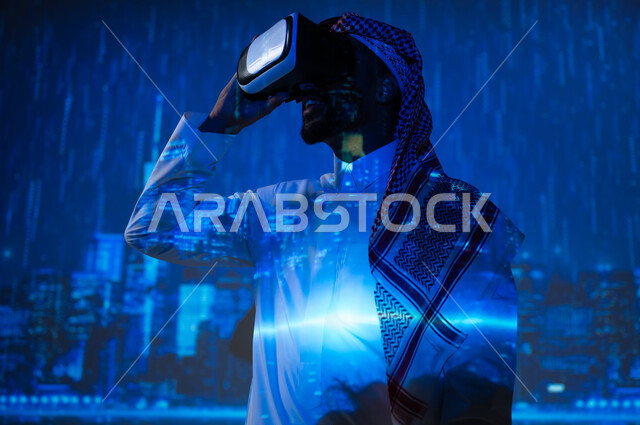 رؤية سعودية مستقبلية٢٠٣٠، مشاهدة فصل الشتاء الماطر، الأجواء الممطرة في المملكة العربية السعودية، شاب عربي سعودي خليجي يرتدي الزي التقليدي والشماغ يقف تحت المطر أمام الأبراج وناطحات السحاب ويضع تظارات الفي ار، زيارة الأماكن المحلية