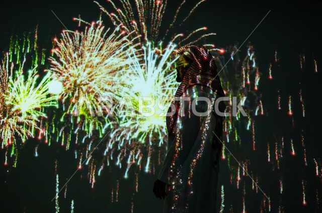 Enjoying fireworks and crackers on holidays and occasions, participating in recreational activities and festive events, a Saudi Gulf Arab young man wearing traditional clothing and a shemagh watching the lights and celebrations