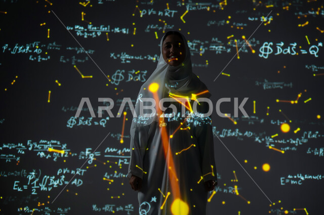 Scientific and technical development in the Kingdom, integrating science with technology, numbers and calculations in mathematics, a smiling Saudi Arabian Gulf woman, veiled and wearing an abaya, looking at the camera with gestures of happiness and pleasure, background laws and mathematical algorithms.