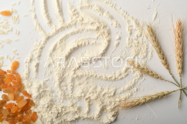 مجموعة من الأرز والزبيب والطحين على خلفية بيضاء