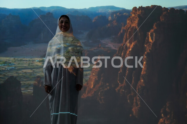 Rock formations in desert areas, mountain peaks and heights, a smiling, veiled Saudi Arabian Gulf woman looking at the camera with gestures of happiness and pleasure, landmarks and archaeological historical tourist places in Al-Ula Governorate.