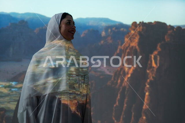 معالم وأماكن سياحية تاريخية أثرية في محافظة العلا، التكوينات الصخرية في المناطق الصحراوية، امرأة عربية خليجية سعودية مبتسمة محجبة ترتدي العباءة تنظر الى شيء ما، القمم والمرتفعات الجبلية