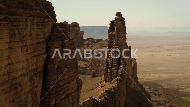 Rock formations and formations in the desert of Al-Ula Governorate, mountain peaks and heights in the sandy environment, natural landscapes in the desert regions of the Kingdom of Saudi Arabia, ancient historical monuments, famous tourist places.