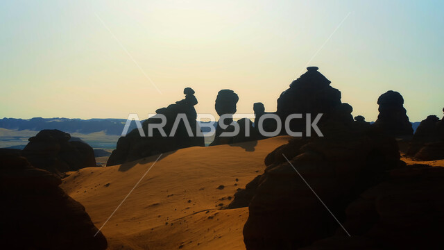 Rock formations and formations in the desert of Al-Ula Governorate, mountain peaks and heights in the sandy environment, natural landscapes in the desert regions of the Kingdom of Saudi Arabia, ancient historical monuments, famous tourist places.