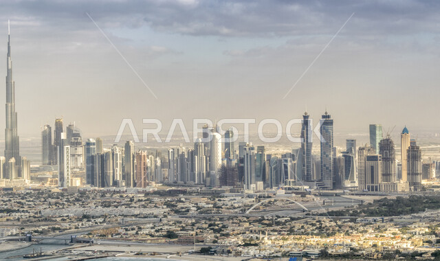 منظر السماء بالغيوم الملبدة، الفن الهندسي المعماري للمباني والمنشآت السكنية والتجارية، برج خلفية في دبي، التوسع والتقدم العمراني في دولة الإمارات العربية المتحدة، صورة بالأبيض والأسود للأبراج وناطحات السحاب
