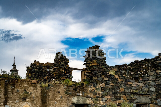 Ancient historical monuments in mountain villages, ancient architectural design of buildings and castles in the Al-Baha region, heritage places to attract tourists from all over the world, famous tourist attractions, building made of stones and trunks of Sidr trees, view of the sky filled with clouds