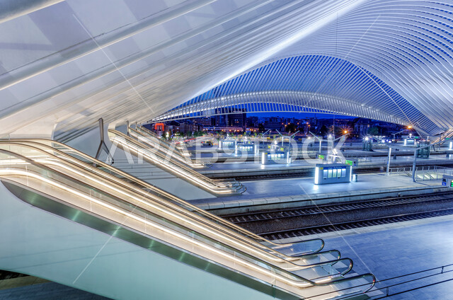 Modern escalators in one of the illuminated malls at night, modern architectural art for commercial markets in the Kingdom of Saudi Arabia, modern engineering designs and decorations