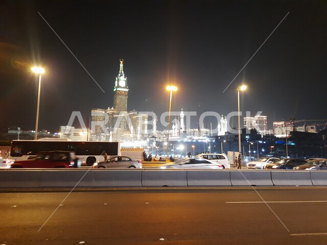 Makkah Al-Mukarramah towers and hotels, the illuminated clock tower and skyscrapers, famous cities and landmarks in Saudi Arabia, contemporary architectural construction, wide streets and roads illuminated with high lights, urban growth and development in the Kingdom