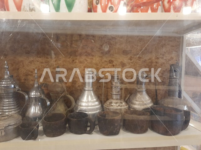 Utensils for hot and cold drinks, traditional household utensils, a close-up of a group of copper jugs and old cups in the Museum of the Living Air Museum in the village of Jarda Bin Ali in Al-Hajra Governorate, tourism in the Al-Bahah region in the Kingdom of Saudi Arabia