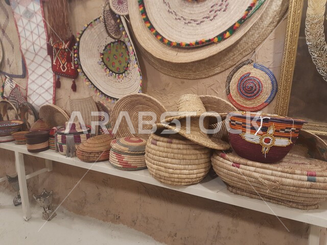 Saudi national local production, pride in popular handicrafts, ancient traditional crafts and professions, a group of straw crafts and wicker palm leaves displayed in the Museum of the Living Air Museum in the village of Jarda Bin Ali in Al-Hajra Governorate in Al-Bahah Province, tourism in the Kingdom of Saudi Arabia