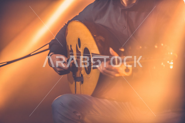  شاب عربي سعودي أنيق يعزف على الجيتار, الغيتار (الجيتار أو القِيثَارَة ) آلة موسيقية وترية بأوتار مدقوقة , عزف الموسيقى الهادئة الراقية