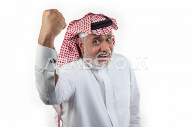 Portrait of an elderly Saudi Arab man raising his fist while smiling with different facial and hand gestures, close-up, a young Saudi man wearing a white dress with a shemagh and headband, white background, an elderly man raising his hand in a state of ha