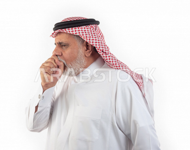 Portrait of an elderly Saudi Arab man who puts his hand in front of his mouth while coughing with different facial and hands gestures, close-up, a young Saudi man wearing a white dress with a shemagh and headband, white background, a side view of an elder