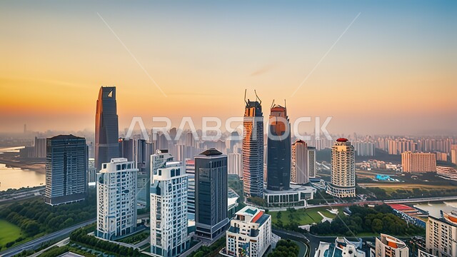  المدن السياحية الساحلية، الفن الهندسي المعماري المتطور للمنشآت التجارية والسكنية في شاطئ جميرة، المباني والمنتجعات الفاخرة في الإمارات العربية المتحدة، صورة جوية لناطحات السحاب والأبراج في مرسى دبي وقت غروب الشمس