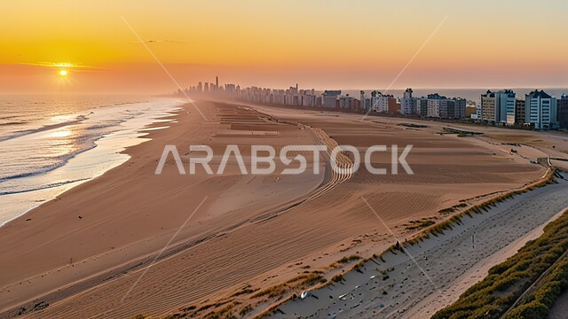 الشاطئ الرملي للبحر في مدينة جدة وقت غروب الشمس، معالم واماكن جذب سياحية في المملكة العربية السعودية، الواجهه البحرية المطلة على ساحل البحر الاحمر، التطور والنمو العمراني للمنشآت وناطحات السحاب