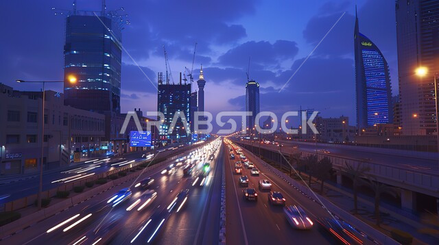 Traffic in the streets of Riyadh at night, urban growth and progress in the Kingdom of Saudi Arabia, towers and skyscrapers and development in architecture, lights of buildings and cars in the capital