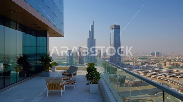 الاهتمام بزراعة النباتات الخضراء ,الفن الهندسي المعماري للشقق والمنازل في الامارات العربية المتحدة، شرفة منزل بديكورات أنيقة مطلة على الابراج، أثاث بسيط ومريح, مفهوم الاسترخاء و الاستمتاع بالاجواء الهادئة