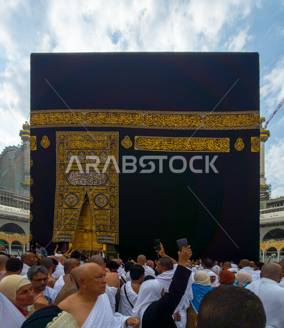 Circumambulating around the Holy Kaaba, worship and getting closer to God, pilgrims circumambulating around the Kaaba in the Holy Mosque of Mecca in the Holy City of Mecca in the Kingdom of Saudi Arabia, performing Hajj and Umrah rituals, obedience, acts of worship and obligations in Islam