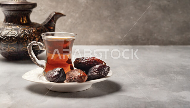 Local products and crops of Saudi Arabia, fresh dates with a cup of tea, hot healthy drinks, a meal with high nutritional value, a healthy and useful breakfast