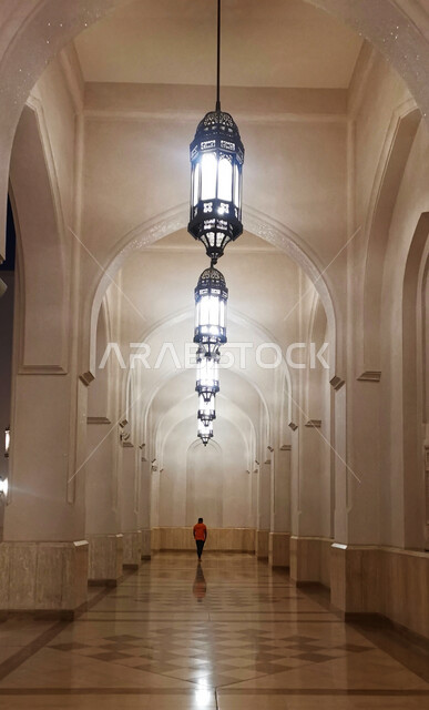 ممر داخل مسجد السلطان قابوس في محافظة الداخلية في ولاية نزوى، أماكن ومعالم إسلامية دينية مشهورة في سلطنة عمان، الديكورات والفوانيس الكبيرة الفاخرة المعلقة في السقف داخل المسجد، العبادة والتقرب الى الله، أداء الفرائض الدينية، الفن الهندسي المعماري الاسلامي الحديث
