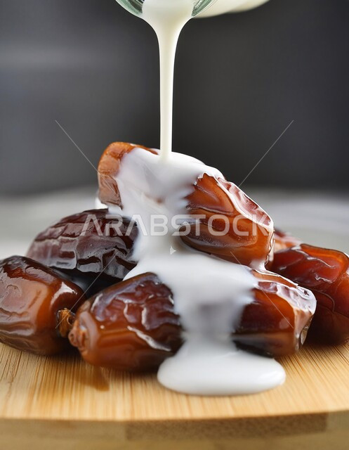 Hospitality and generous reception on holidays and religious occasions in the Kingdom of Saudi Arabia, a healthy Ramadan breakfast, food with high nutritional value, a close-up of a plate of sugary dates with milk, types of delicious dates