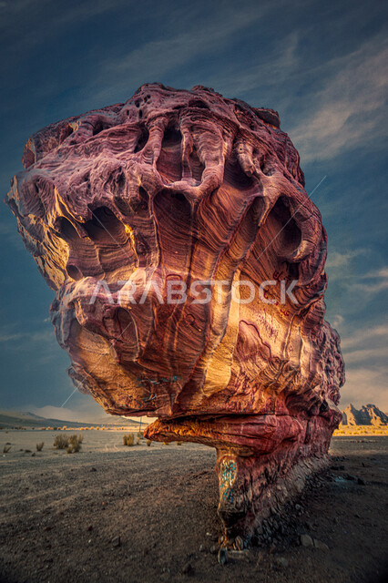 Rock sculpture and relief in desert areas, natural rock formations and formations in the Kingdom of Saudi Arabia, a large rock in the Tabuk desert, famous tourist attractions, a view of the clouds in the sky at night time