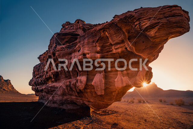 Famous tourist attractions and places, rock formations and formations in the Kingdom of Saudi Arabia, a large rock in the Tabuk desert at sunset, natural sculpture of stones and rocks.