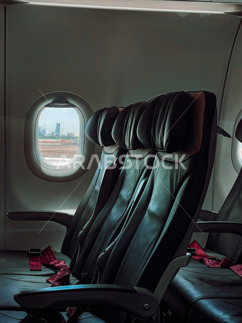 Air transportation in Jeddah, a picture from inside the plane of comfortable seats and a window, airlines in the Kingdom of Saudi Arabia, tourism, travel and long-distance trips
