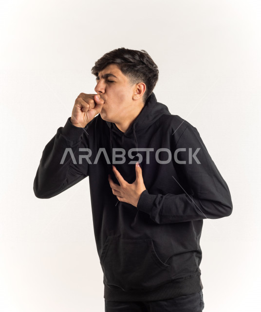 Portrait of a young Saudi Arabian Gulf teenager putting his hand in front of his mouth while coughing with different facial and hands gestures, white background