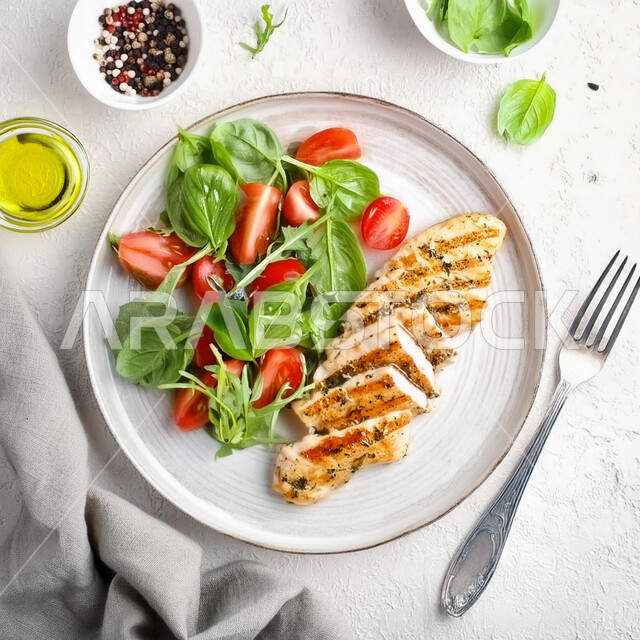 Distinctive recipes and dishes in the kitchens of the Kingdom of Saudi Arabia, delicious oriental Arabic food, healthy chicken meals, a picture from the top of a plate of fillet pieces with vegetables, fast food restaurants, white background.
