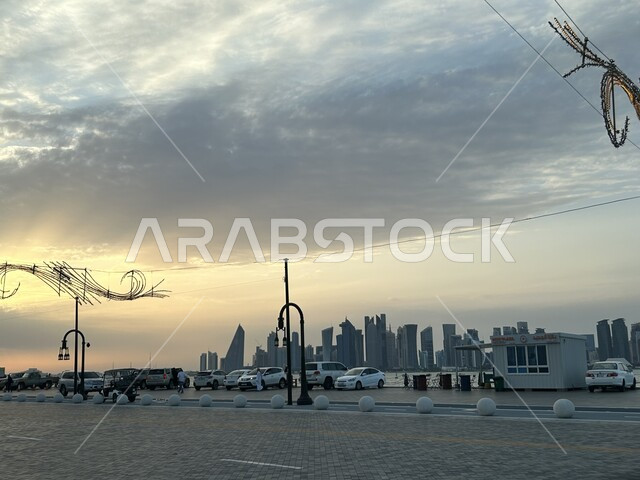 النمو والتقدم العمراني في الطرقات والمباني, مشهد للسماء المليئة بالغيوم في وقت الغروب, ميناء الدوحة في قطر, خلفية الابراج وناطحات السحاب والعمائر العالية