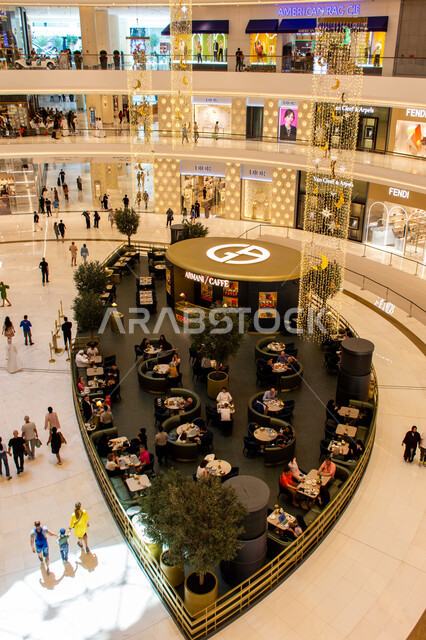 Modern designs for stores and restaurants inside Dubai Mall, the largest commercial complex in the world, tourism in the United Arab Emirates, shopping centers and luxury stores, a picture from above of tourists and visitors sitting in cafes, places for recreational family activities