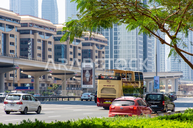 Means of transportation and rapid communication in the Emirates, cars on Sheikh Zayed Road, transportation and traffic within the city of Dubai, urban development in the streets, roads, and directional signs.