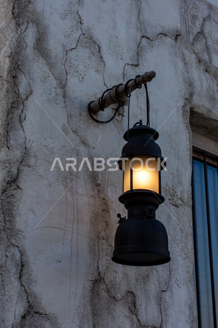 A picture of a traditional Arabic lantern hanging on the wall in the historical area of ​​Shindagha in the Dubai Creek neighborhood in the United Arab Emirates, tourism in the Emirates, famous tourist archaeological landmarks in the Emirates, historical h