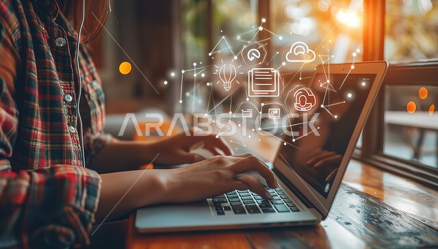 E-marketing and internet browsing, professional computer and information technology jobs, set of icons for computer applications, close-up of hands of a young Saudi Arabian Gulf woman working on a laptop